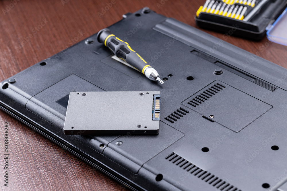 Poster repairing and upgrading laptop computer. new solid state drive on a laptop. computer maintenance ser