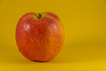 red apple on a yellow background