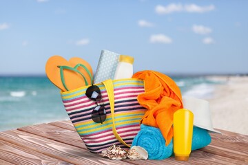 Bag with flip flops, sunglasses and summer accessories