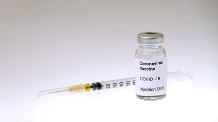 The syringe to inject the vaccine Covid-19 and the bottle containing the coronavirus vaccine