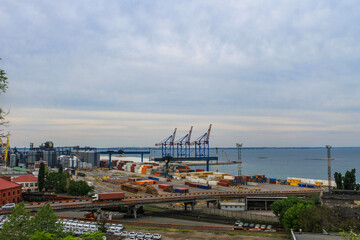 Hoisting cranes, transport containers and granaries at cargo sea port in Odessa, Ukraine