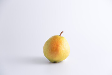 Isolated single fresh pear over white studio with copy space and vivid image