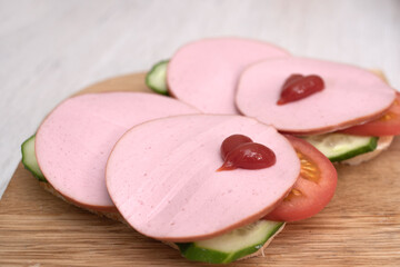 Sandwiches for lovers. Sausage and ketchup. Valentine's day breakfast