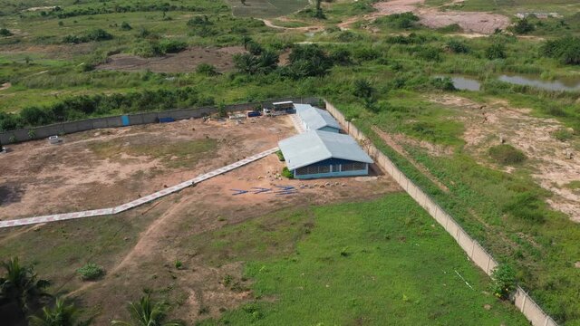 Aerial orphanage school building rural Ghana. Homes, apartment, playgrounds, library and facilities to help young boys and girls escape slave and child labor. Volunteer facility. Tropical forest land