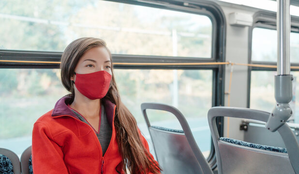 Bus travel during coronavirus. Asian woman commuter wearing mask riding public transport commuting as prevention. Safety in city outdoor indoor people lifestyle.