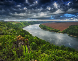 Beautiful spring landscape at sunrise. clouds over a picturesque canyon