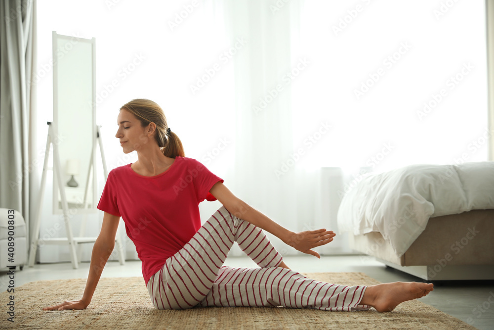 Poster Young woman doing gymnastics on floor at home. Morning fitness