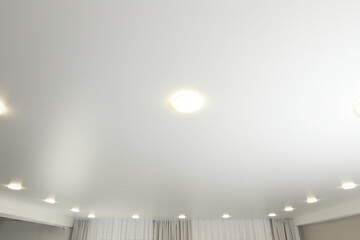 White ceiling with lamps indoors, below view