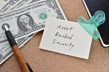 On the desk were bills, a notebook, and memos with the word Asset Backed Security written on it.