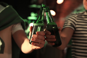 Men with beer celebrating St Patrick's day in pub, closeup