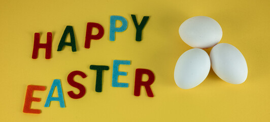 Happy Easter greeting card with three white eggs