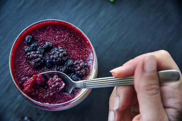 Delicious home made dessert panna cotta with berry sauce, fresh berries and mint in glasses