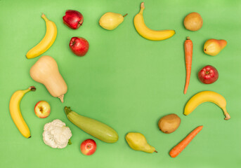 Flat lay composition with fresh organic fruits and vegetables for first baby food on green background. Top view. Healthy child nutrition, baby feeding. Copy space. Diet and vegetarianism. 