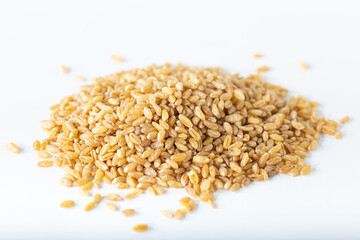 Uncooked bulgur wheat on the isolated on white background.