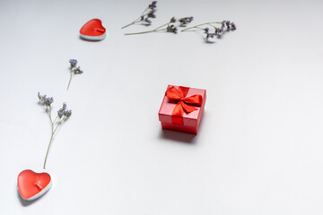 Valentine's day gift with red heart shaped candles and flowers on white background