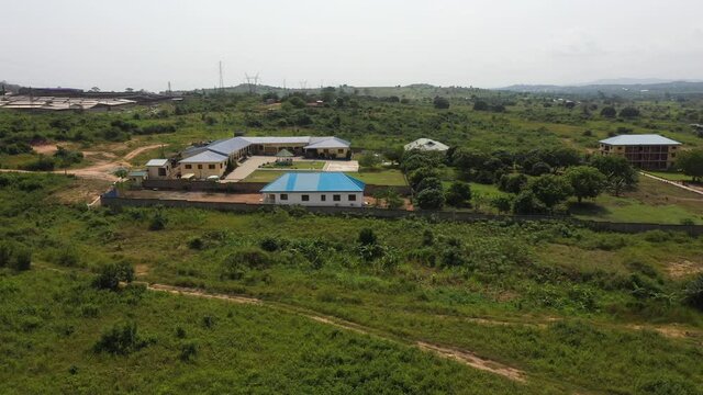 Aerial tropical forest orphanage Ghana Africa. Homes, apartment, playgrounds, library and facilities to help young boys and girls escape slave and child labor. Volunteer facility. Tropical forest land