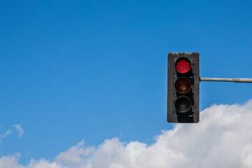 red traffic light on sky