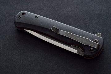 close up of a black and silver folding knife
