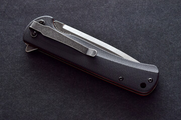 close up of a black and silver folding knife