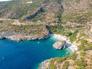 Aerial view of the famous rocky beach Foneas near Kardamyli village in the seaside Messenian Mani area during high tourist Summer period. Messenia, Peloponnese, Greece.