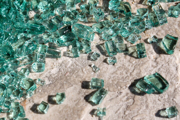 Fragments of blue-green glass on the floor