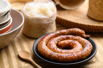 Northern Thai sausage (Sai Aua), Grilled intestine stuffed with minced pork, spices and herbs eating with sticky rice, popular food in Chiangmai, Thailand