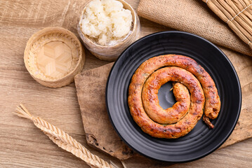 Northern Thai sausage (Sai Aua), Grilled intestine stuffed with minced pork, spices and herbs eating with sticky rice, popular food in Chiangmai, Thailand