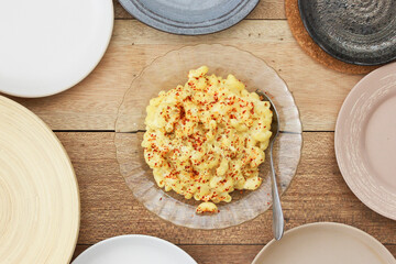 scrambles eggs for dinner on top of wooden table.