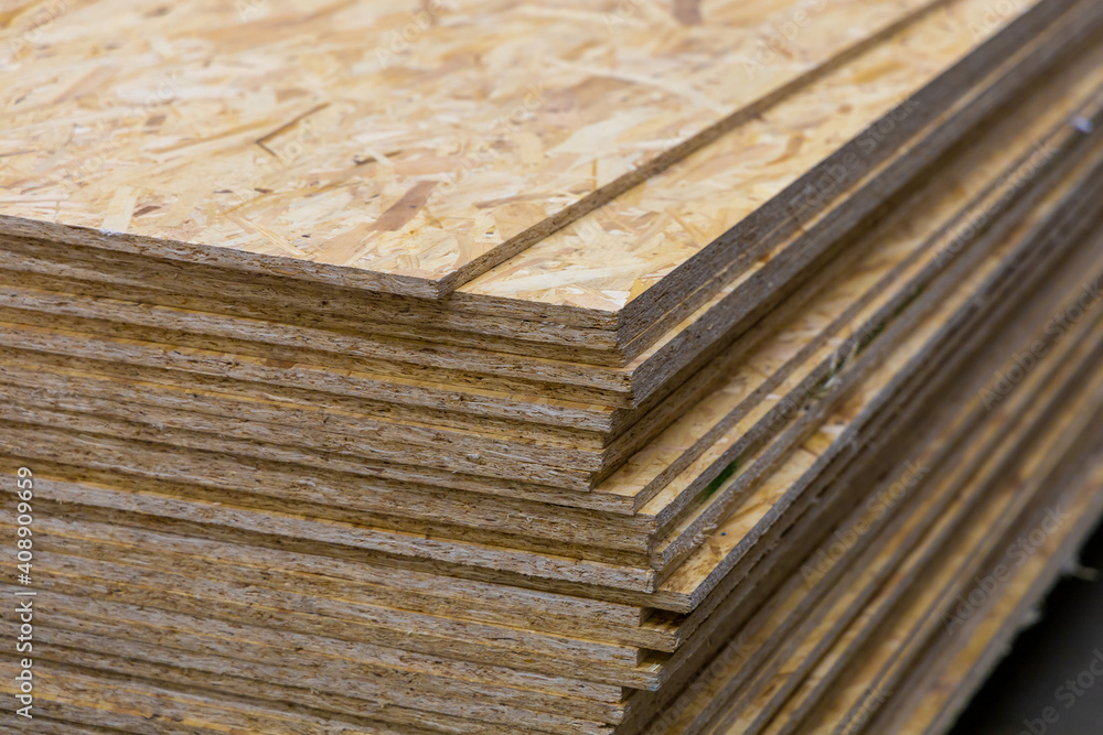 Wall mural osb - oriented strand board. sheet stack in a construction store. engineered wood product for load-b