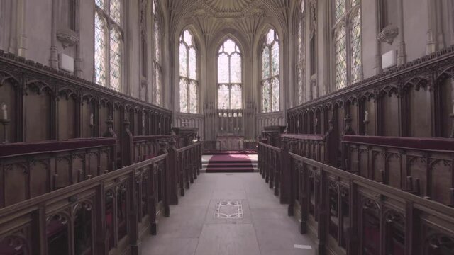 Moving forward through small chapel church cathedral in England stained glass