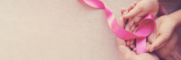 Adult and child hands holding pink ribbons, Breast cancer awareness,  October Pink , world cancer...
