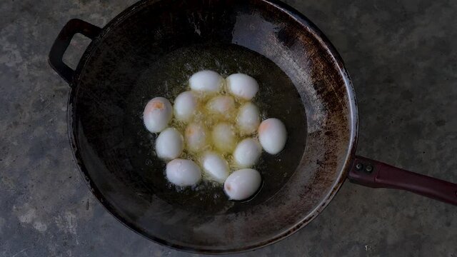 Hard Boiled Eggs Deep Frying In Wok, Top Down Shot