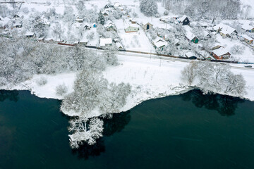 aerial view of winter landscape. village with snow-covered houses and road.