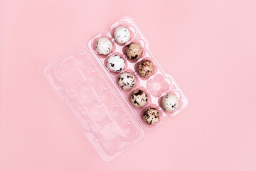 Decorative Easter eggs in plastic package,  chocolate candy on soft pink background. Spring Holiday