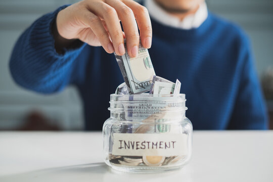 Hand's Man Putting Money In Jar For Investment, Money Plan, Save Money And Management Concept