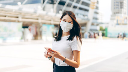 Adult business asian woman wear face mask for protect virus corona or covid19 at outdoor on day.
