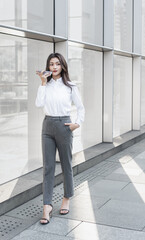 businesswoman talking on cell phone while walking