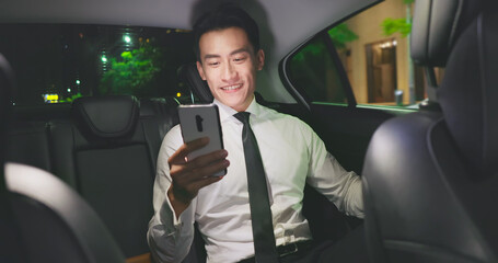 businessman use phone in taxi