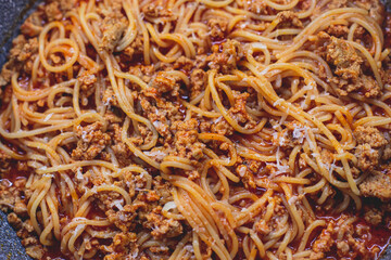 Pasta bolognese pan, homemade prepared close up view, classic italian spaghetti noodle with minced meat beef, tomato sauce and parmesan cheese