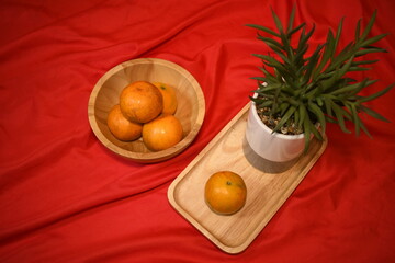 fresh orange on the red sheet table background
