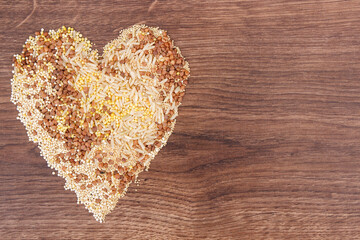 Heart shaped groats, brown rice, amaranth and quinoa seeds, healthy and gluten free food, copy space for text