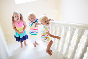 Kids on stairs. Child moving into new home.