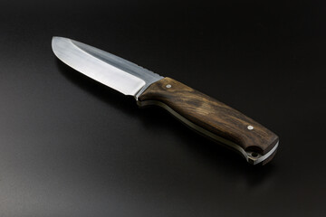 Fixed blade knife isolated on black background.