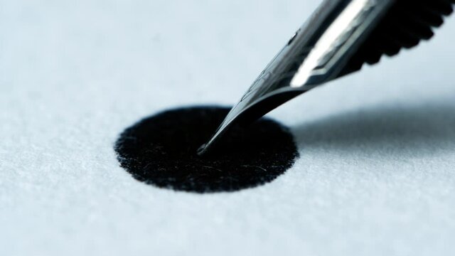 Ink from fountain pen spreading on white paper.