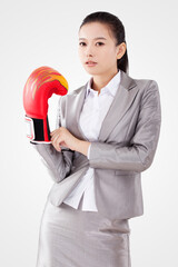 Business woman wearing boxing gloves