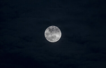 Full moon shining through the clouds