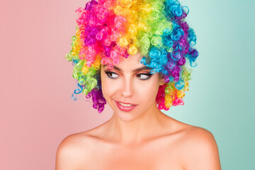 Funny girl clown. Rainbow wig. Funny, laughing, happy girl.