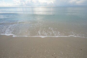 Soft wave on the clear beach in the morning.