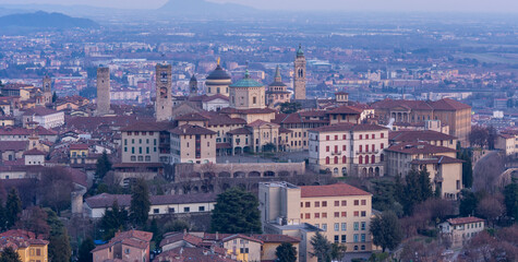 Obraz premium Bergamo. One of the beautiful city in Italy. Landscape at the old town from the hill during sunset. Amazing view of the towers, bell towers and main churches. Touristic destination. Best of Italy