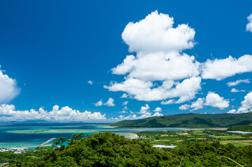 Port of Uehara surrounded by the beautiful turquoise blue sea and green relief of the island of Iriomote seen from the road to Mount Uehara.